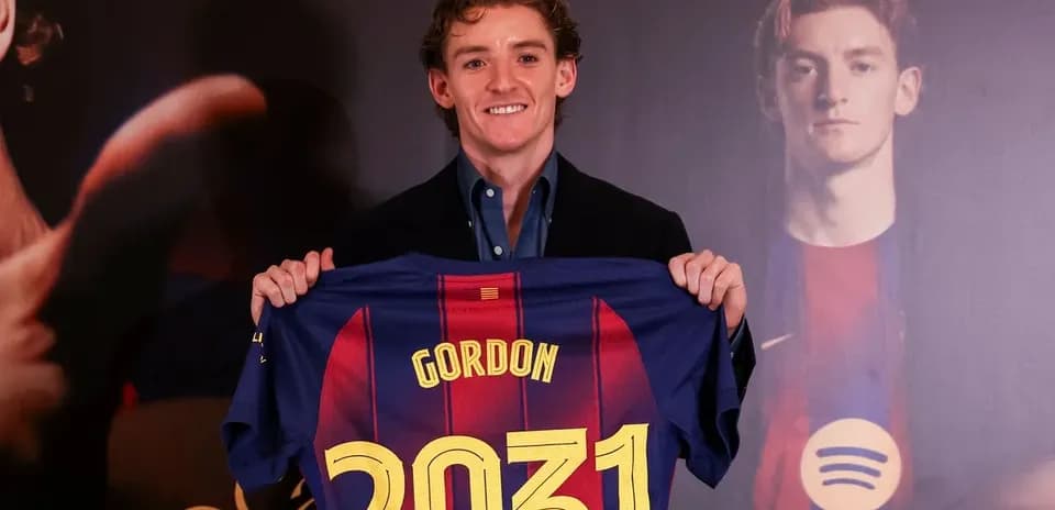 Player holding Barcelona jersey with name and number