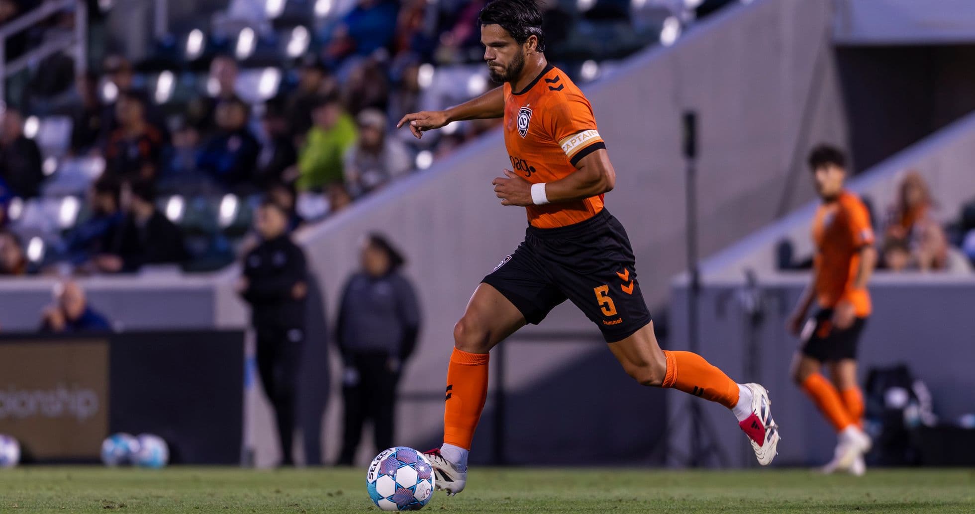 Player dribbling the ball during USL Championship match