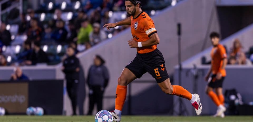 Player dribbling the ball during USL Championship match