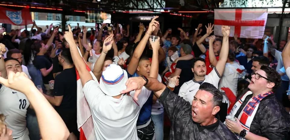Crowd of fans celebrating at sports bar event