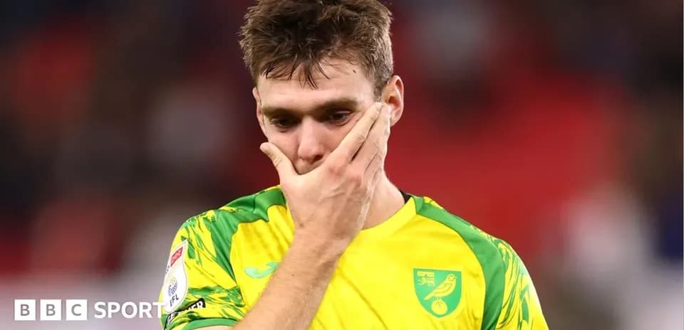 Player in yellow kit showing disappointment after match