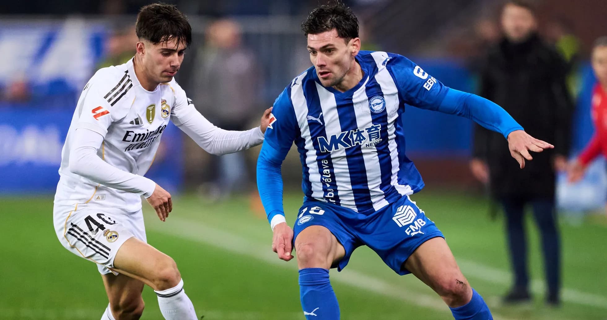 Two football players competing for the ball