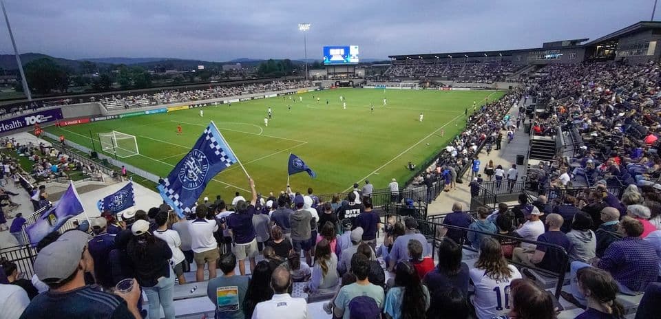 Fans cheering during Huntsville City match
