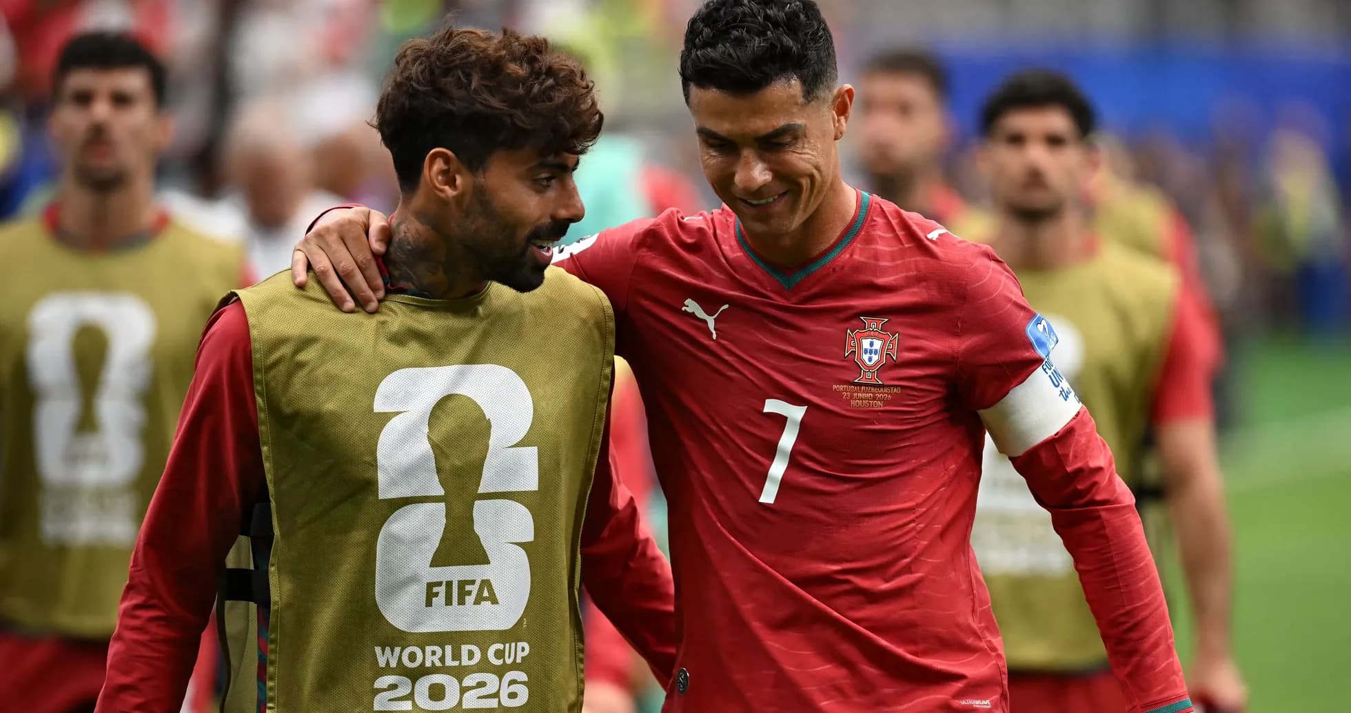 Two players in Portugal kits interacting on field