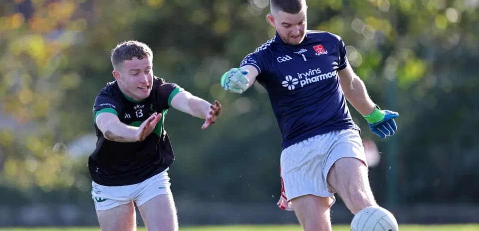 Player kicking the ball while being challenged