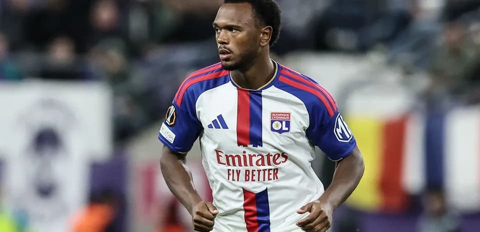 Player in Olympique Lyonnais kit running on field