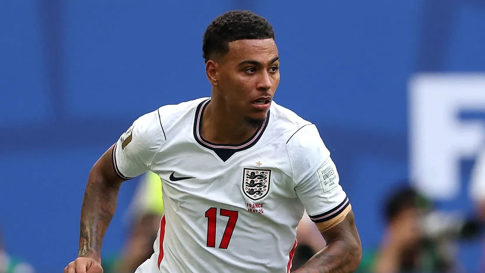 Player sprinting in England kit during match