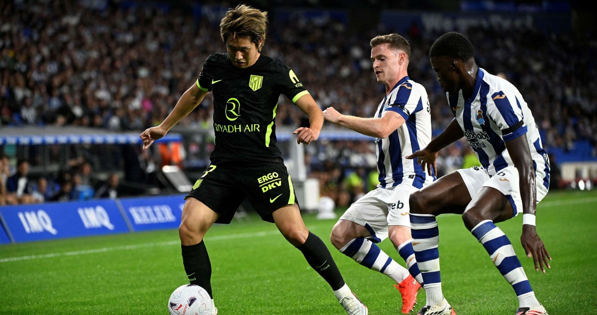 Atletico Madrid player dribbling against Real Sociedad