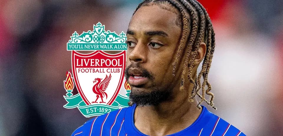 Player in Liverpool kit with club logo in background
