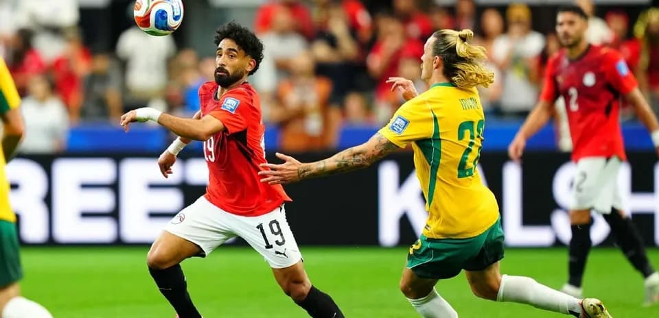 Egyptian player controlling the ball against Australian opponent