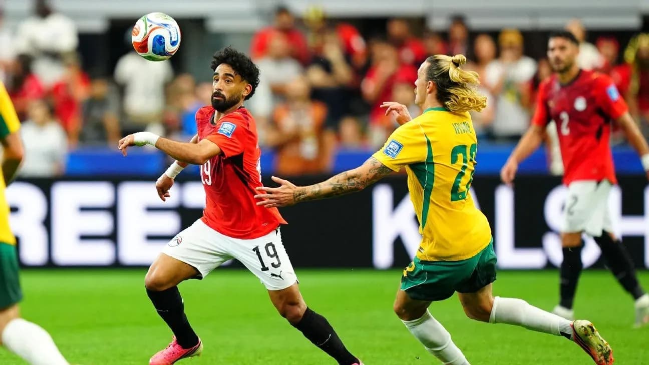 Egyptian player controlling the ball against Australian opponent