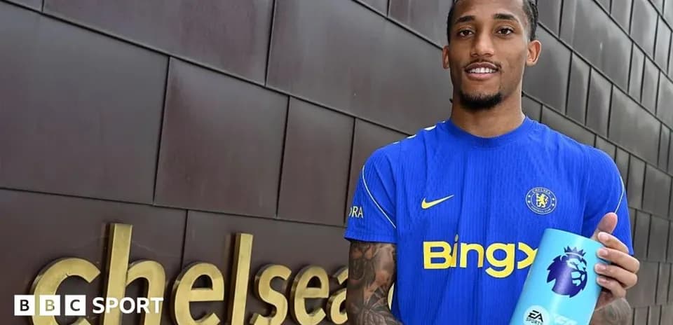 Player holding Premier League award outside Chelsea sign