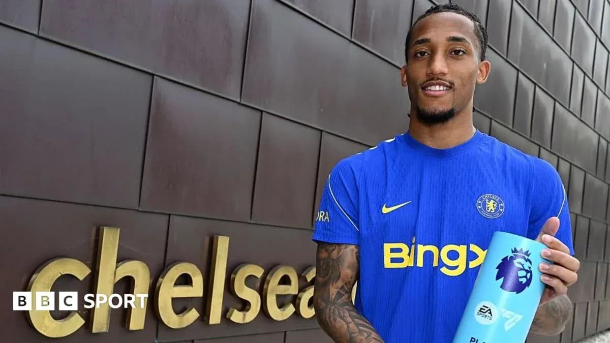 Player holding Premier League award outside Chelsea sign