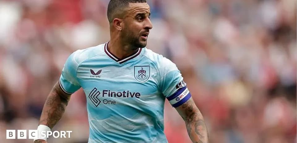 Player in blue kit running on the pitch