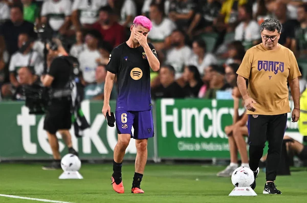 Player with pink hair walking past coach on sideline