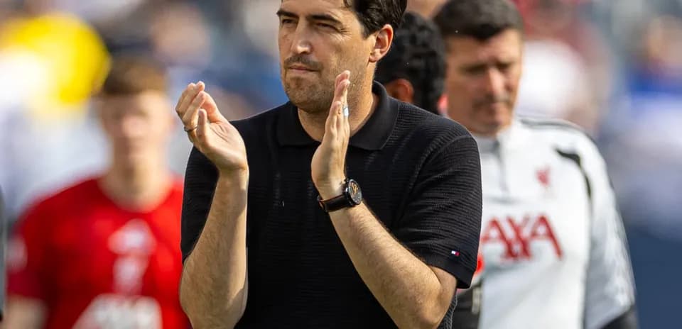 Coach applauding players after the match