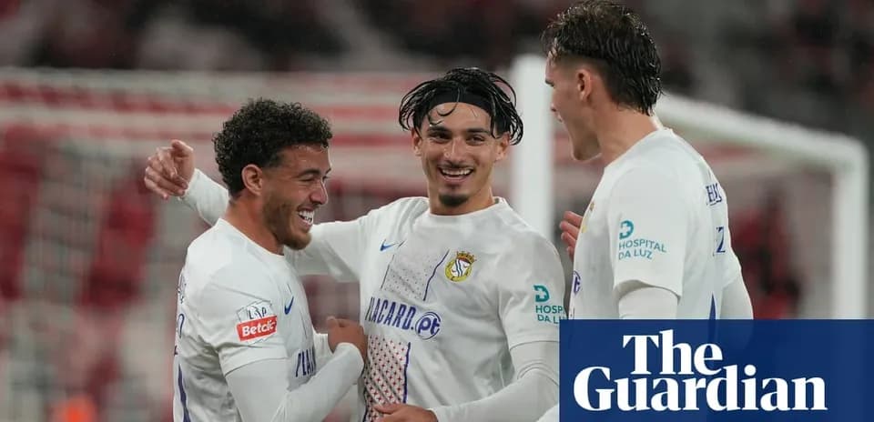 Three players celebrating a goal during match