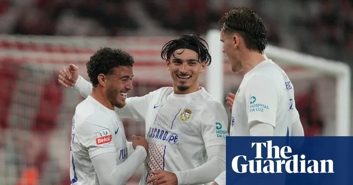 Three players celebrating a goal during match