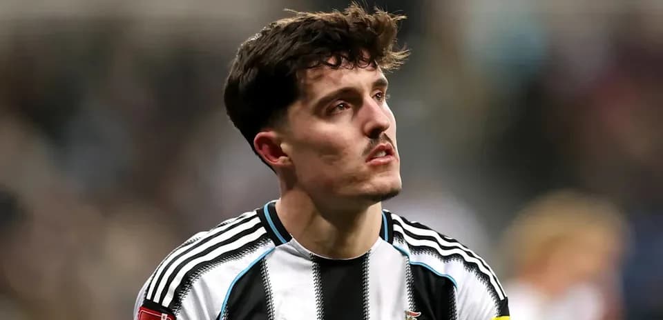 Newcastle player with captain's armband on pitch