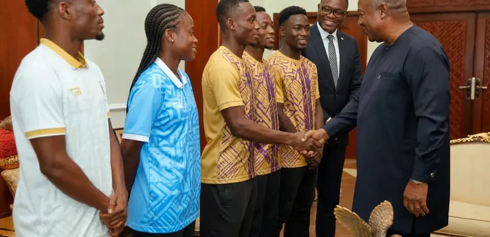 Athletes meeting with official in formal setting