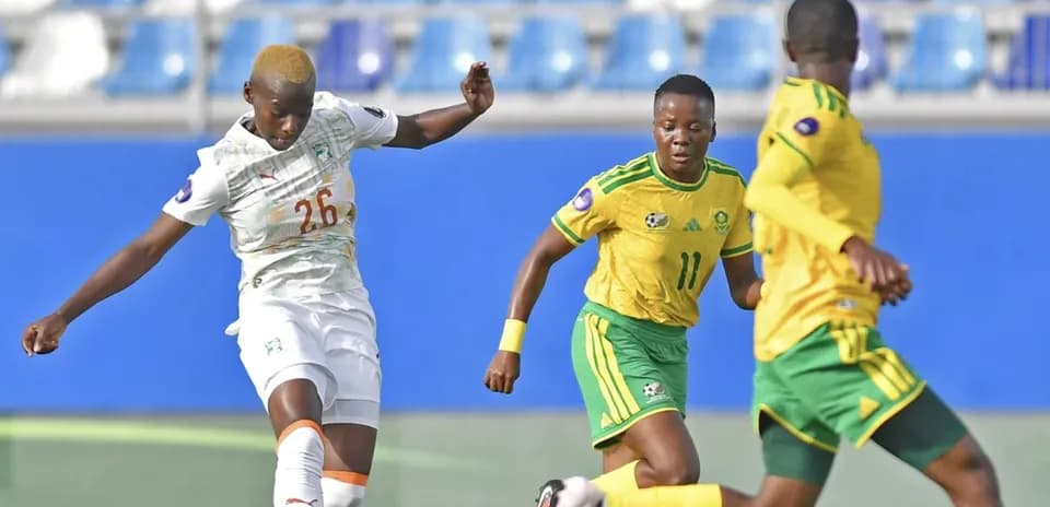Ivorian player kicking the ball during match action