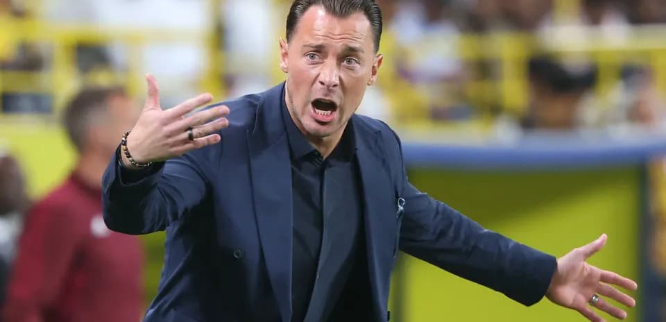Coach gesturing during a match on the sidelines