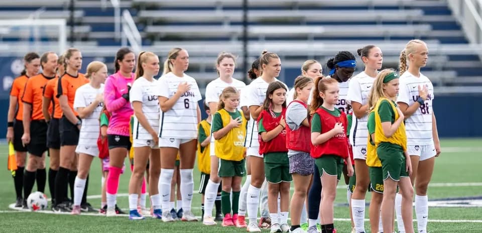 Teams and referees lined up for national anthem