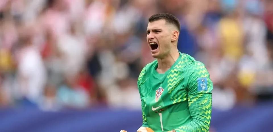 Goalkeeper celebrating during match with fans in background