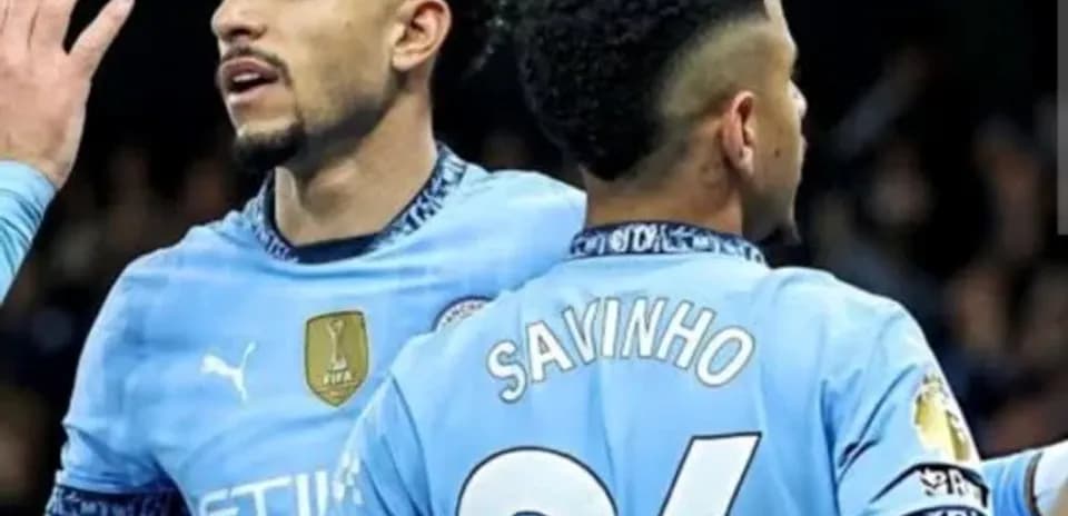 Two Manchester City players celebrating a goal