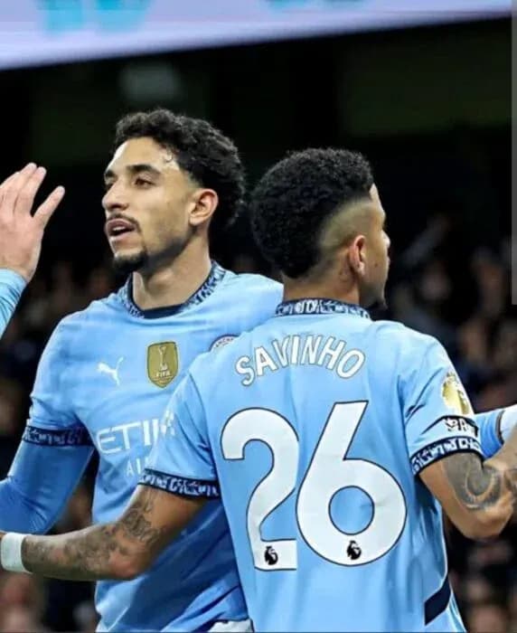 Two Manchester City players celebrating a goal