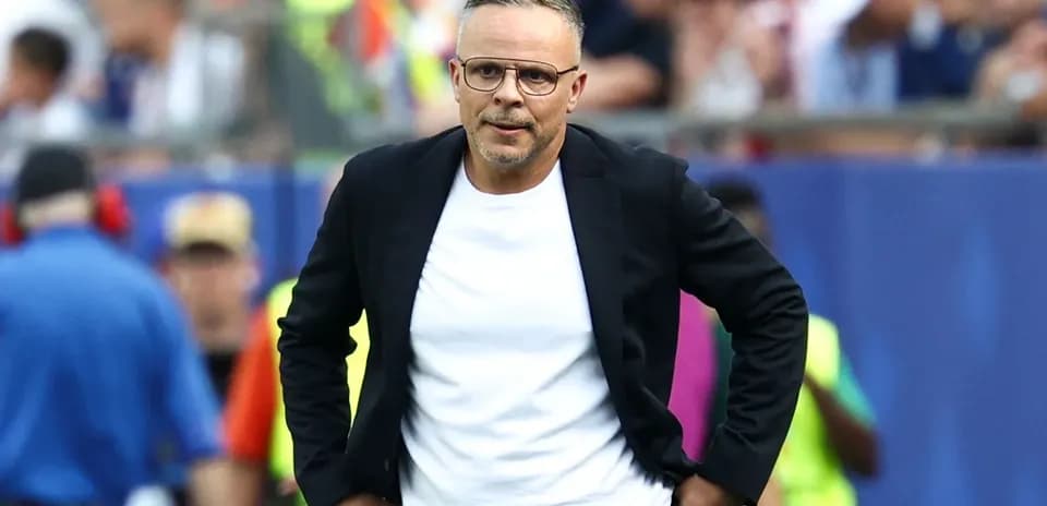 Coach walking along the sideline during match