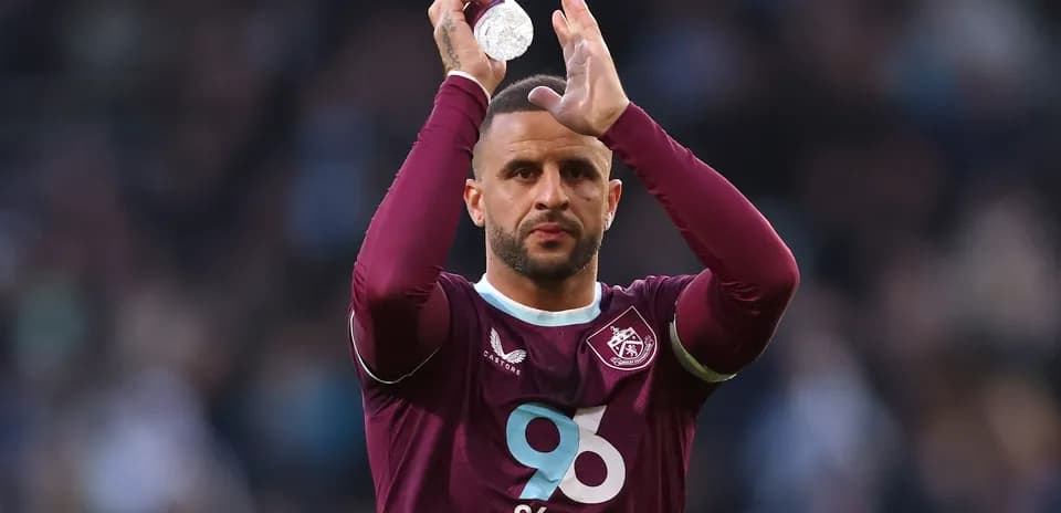 Player applauding fans while holding water bottle