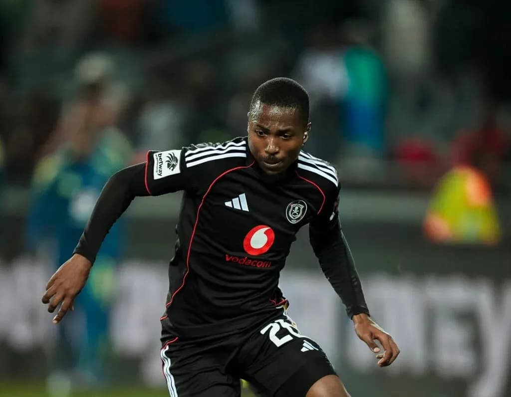 Player in black jersey sprinting on the field