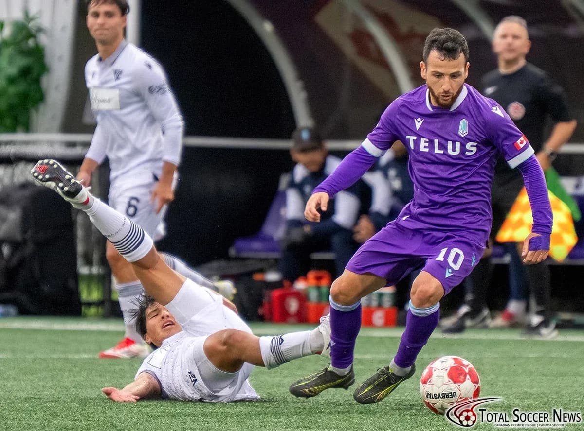 Player dribbling while opponent falls during match