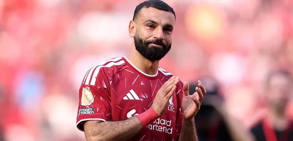 Player applauding fans in Liverpool home stadium