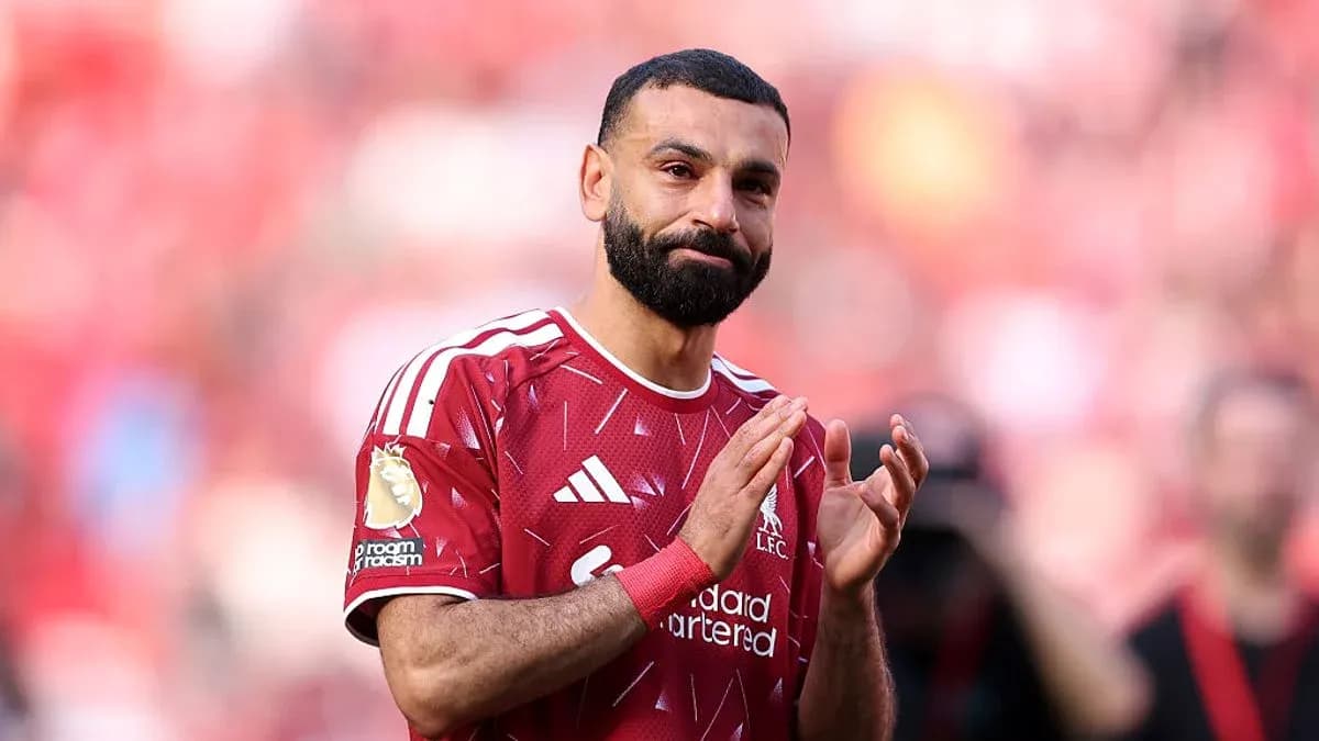 Player applauding fans in Liverpool home stadium