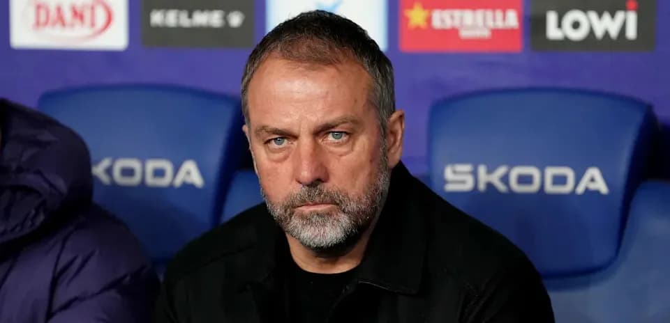 Coach seated on bench during match preparations