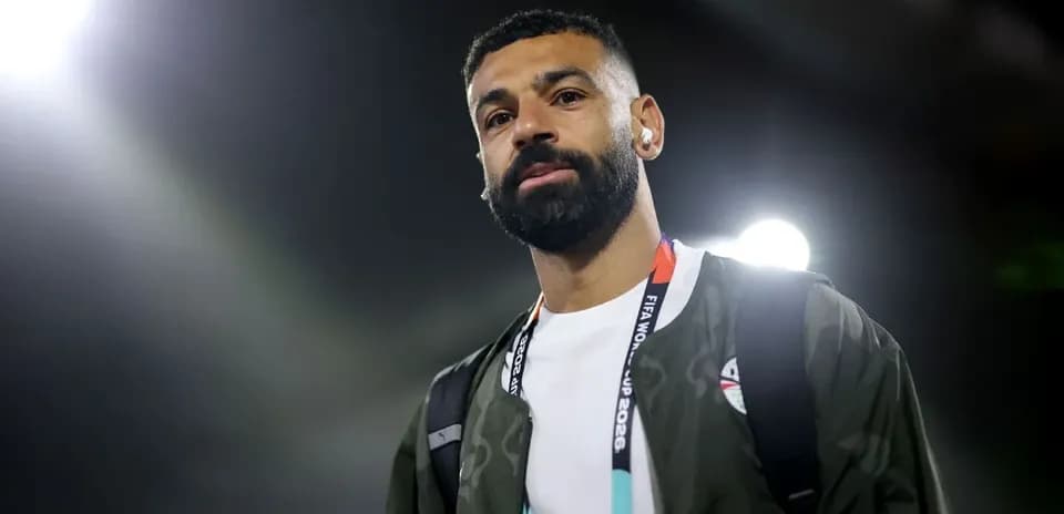 Player walking with backpack at stadium entrance