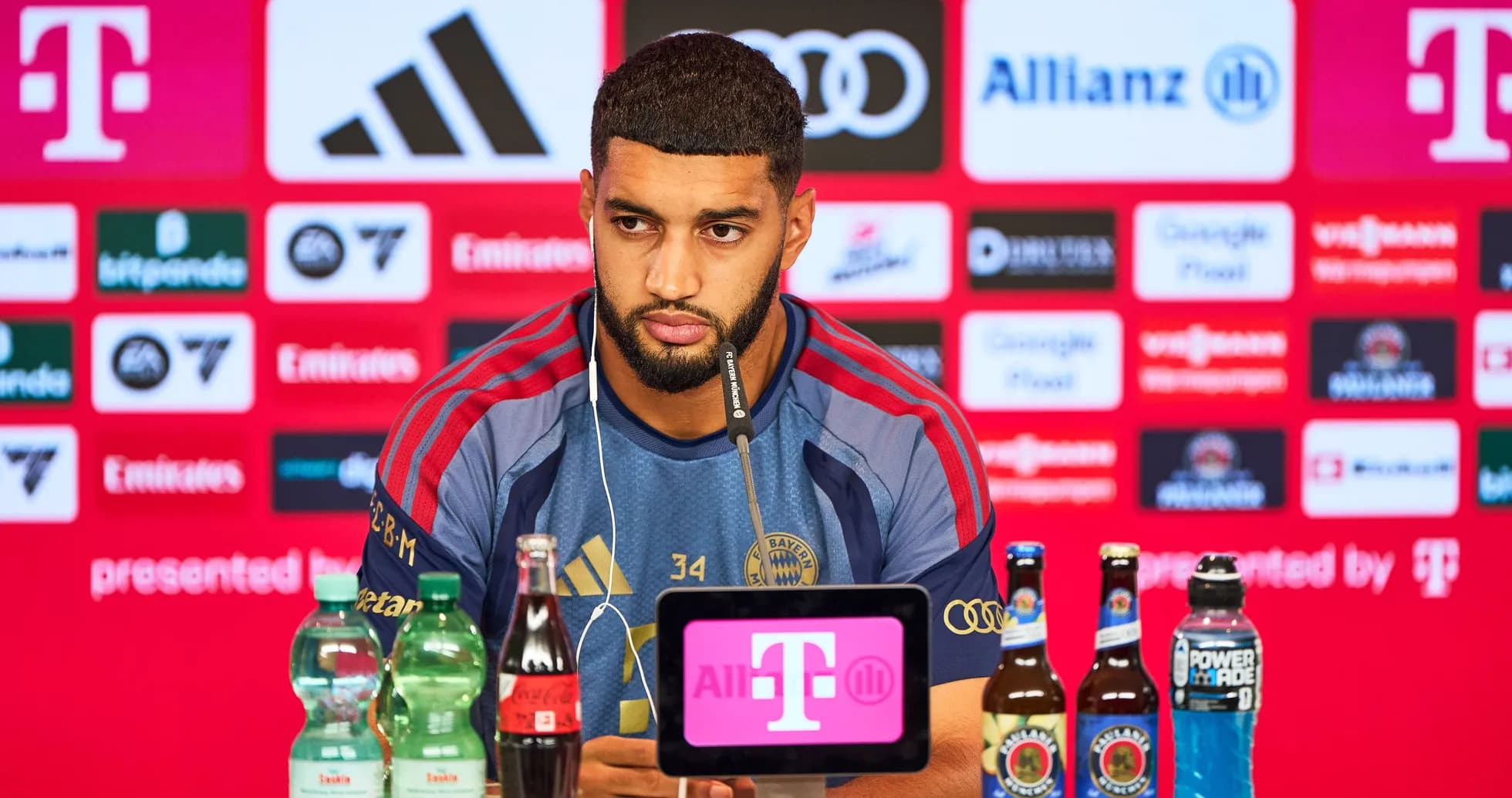 Player at press conference with drinks on table