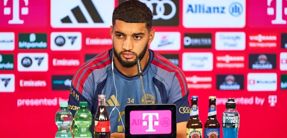 Player at press conference with drinks on table