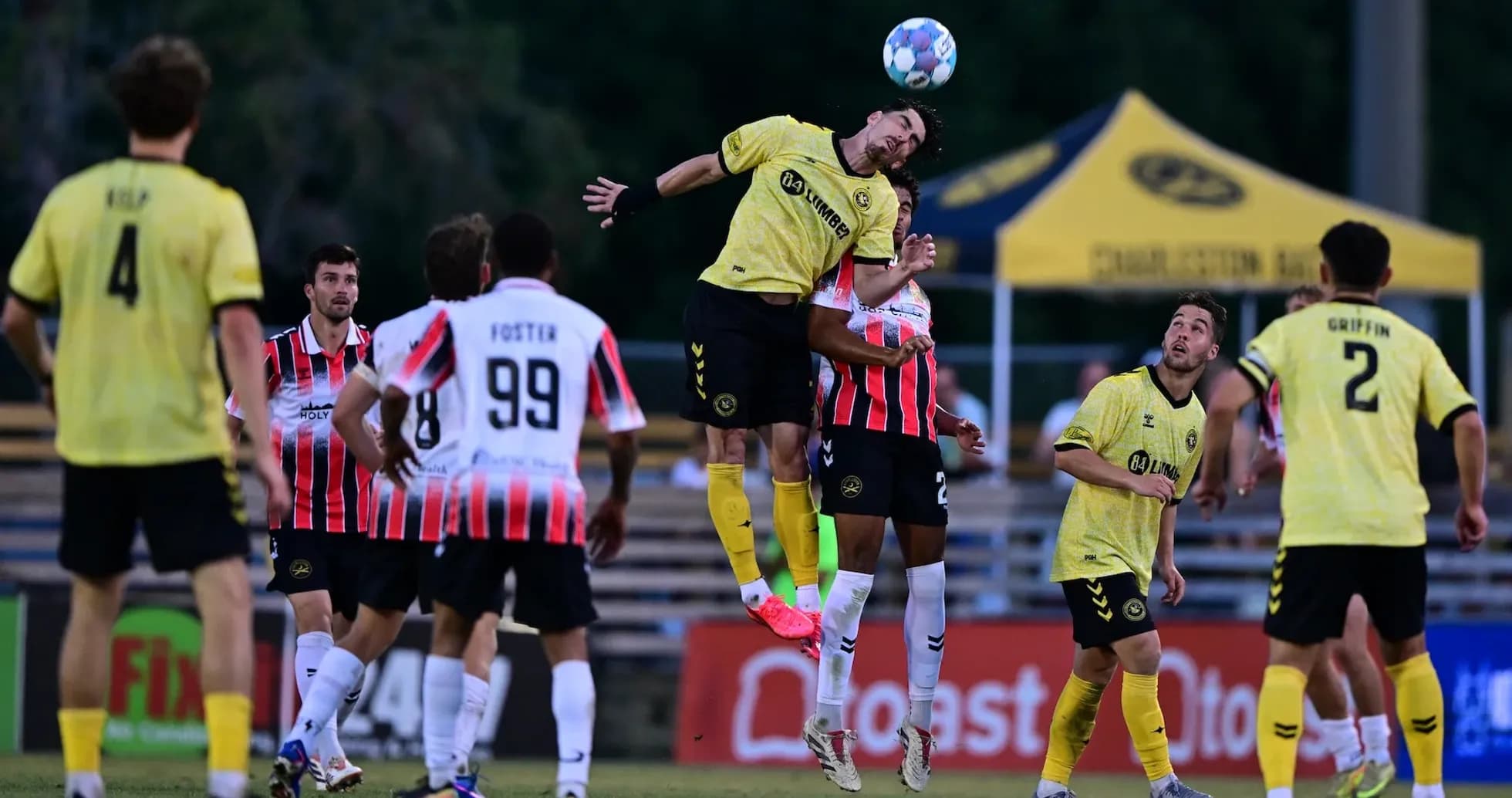 Charleston Battery player heading the ball during match