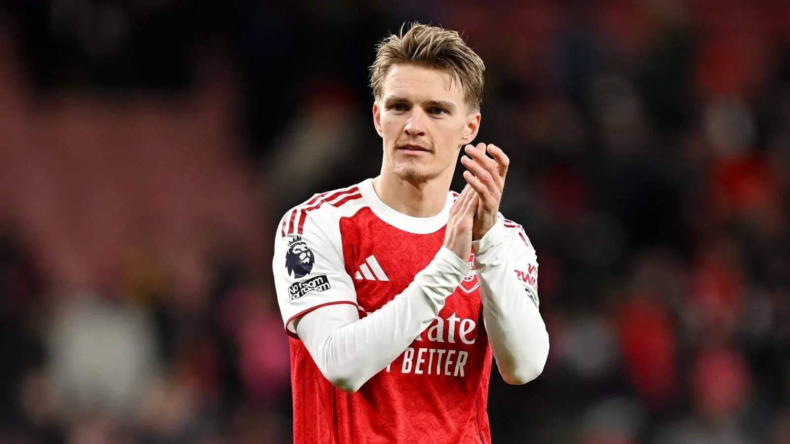Player applauding fans after a match