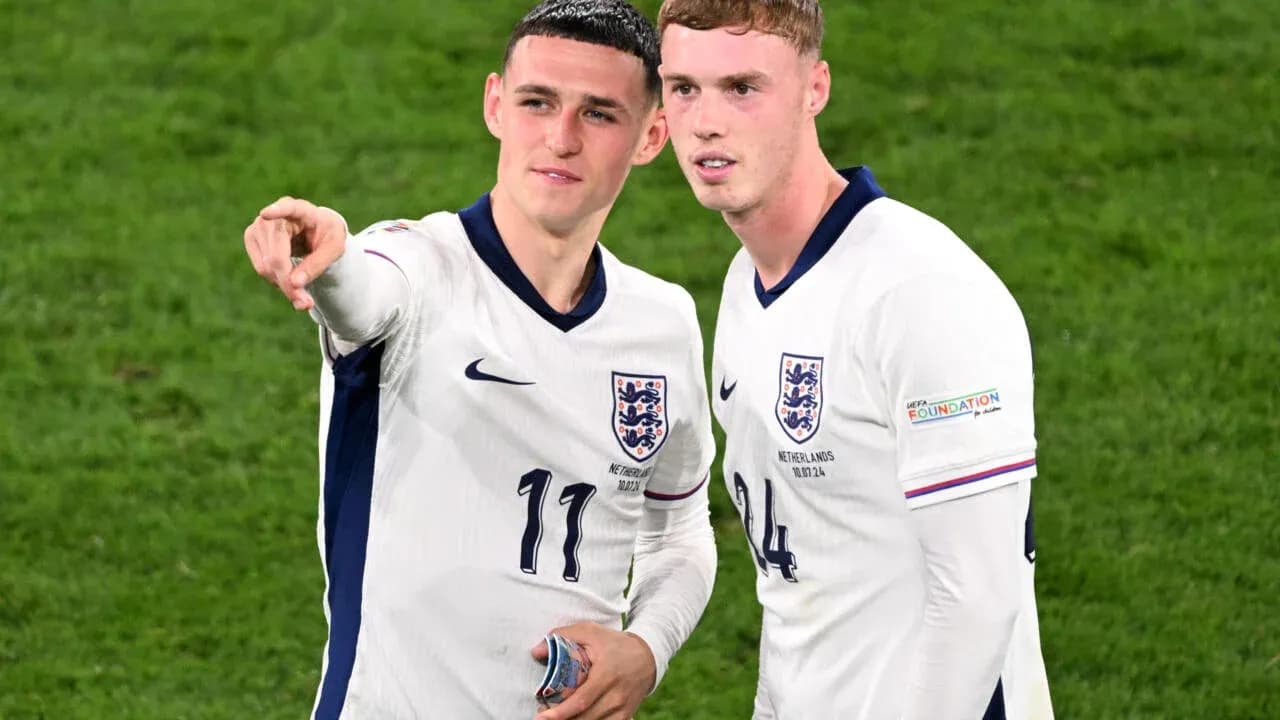 Two England players discussing on the field