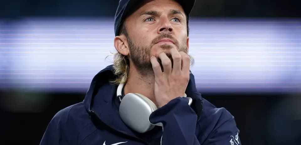Person wearing headphones, pondering during event