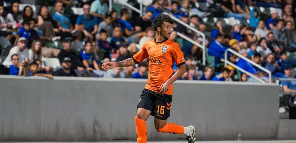 Player in orange kit during USL match