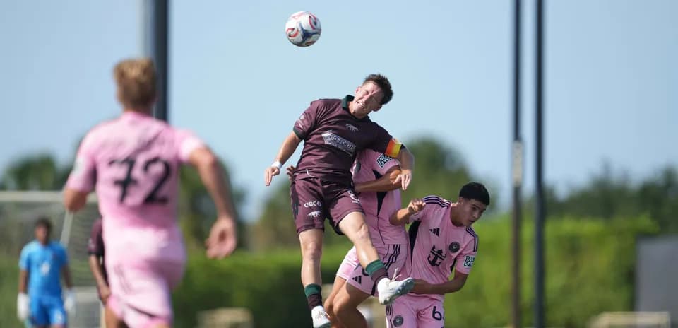 Player heading the ball during match action