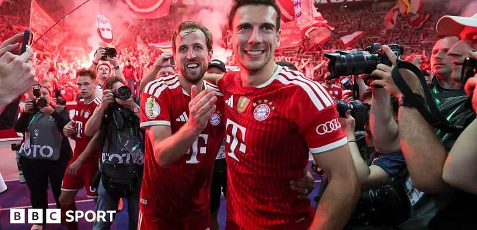 Two Bayern Munich players celebrating with fans