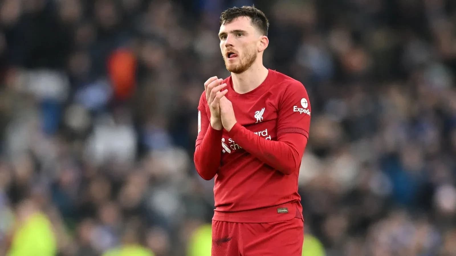 Liverpool player applauding fans after match