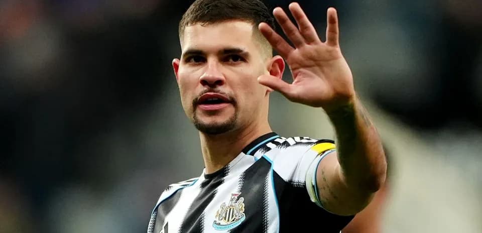 Player waving during a match for Newcastle United