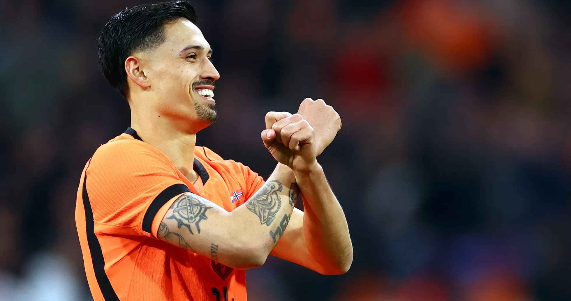 Player celebrating in orange jersey during match
